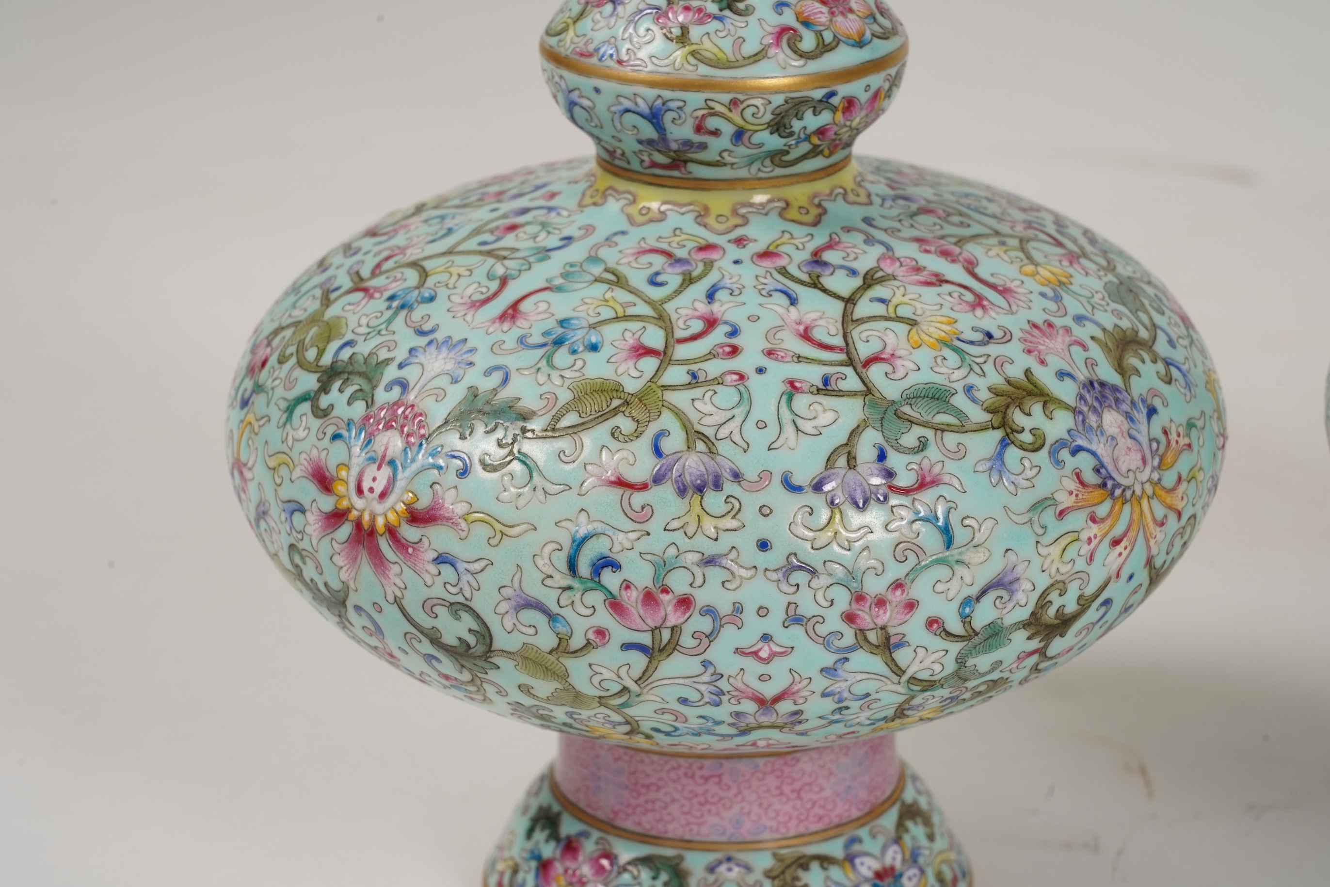 A pair of Chinese famille rose enamelled porcelain bottle vases, Qianlong seal mark to base but Republic Period